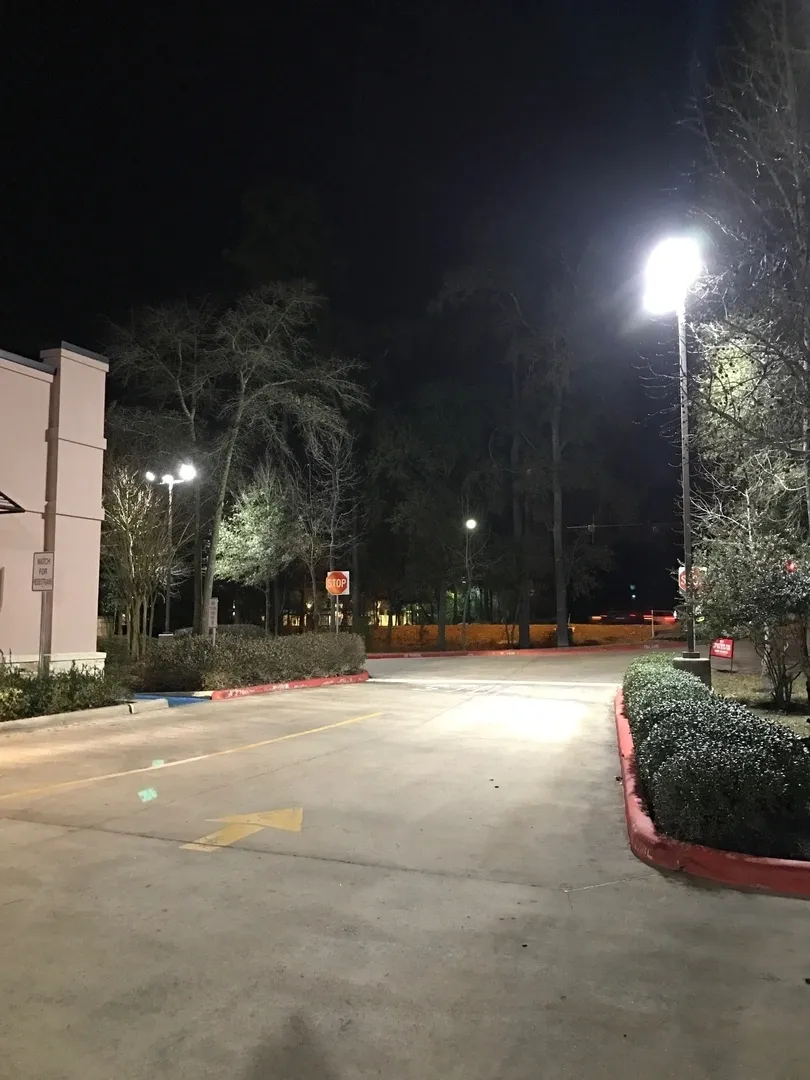 A street light is lit up at night.