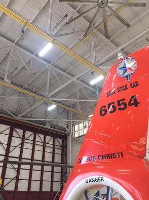 A red airplane in an air hangar with the number 6 3 5 4 on it.