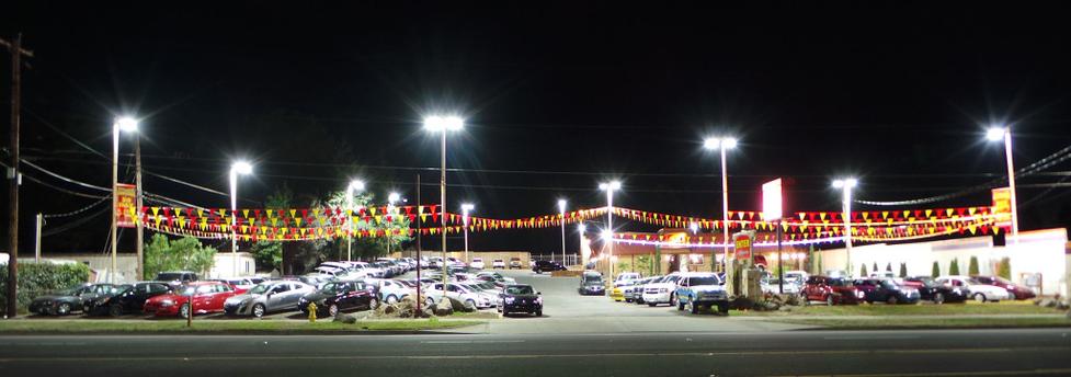 A parking lot with many cars parked in it