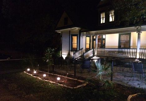 A house with lights on the front lawn