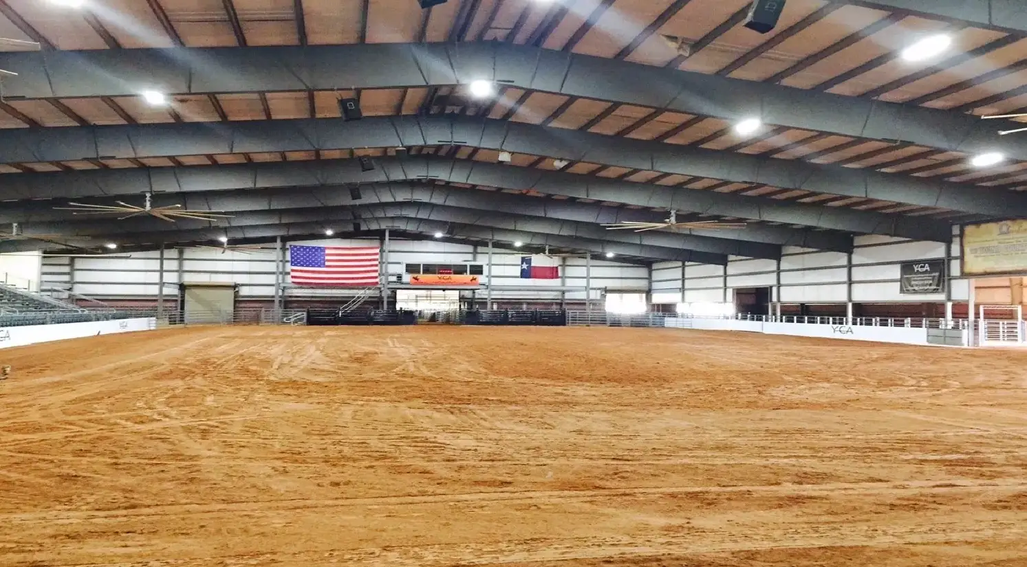 A large arena with an american flag on the wall.