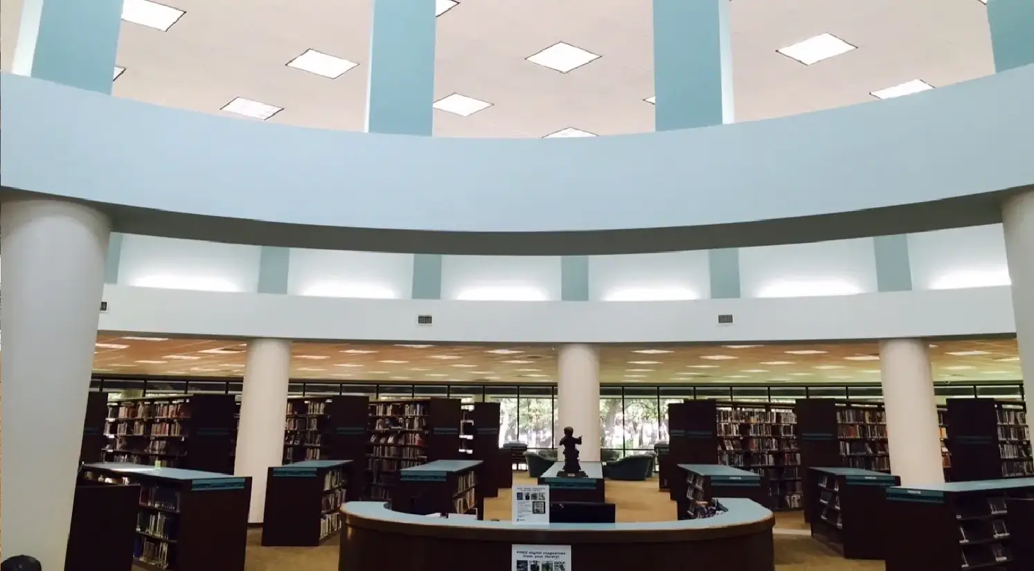 A library with many tables and chairs in it