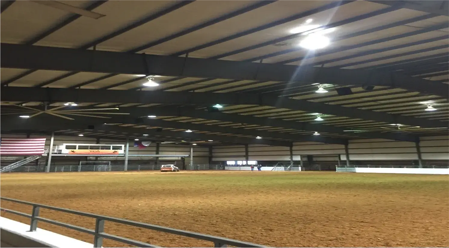 A baseball field with lights on the ceiling.