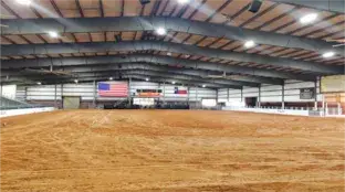 A large empty arena with an american flag on the wall.